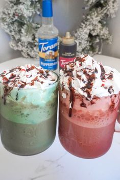 two desserts sitting next to each other on top of a white table in front of a christmas tree