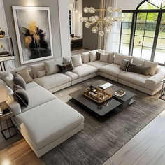 a living room filled with furniture and a large window overlooking the yard in front of it