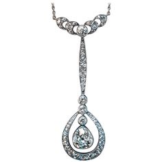 Circa 1910 This stylish antique Edwardian era drop shaped diamond necklace is finely crafted in silver topped 14K gold and platinum (chain). The principal stone of the necklace is a sparkling old pear cut diamond set in a bezel. The diamond measures 6.72 x 6.12 x 3.3 mm and is approximately 0.90 ct (H-I color, SI2 clarity). The necklace is further embellished with bright white old European cut diamonds. Estimated total diamond weight is 2 carats. Length of the pendant 46 mm (1 3/4 in.) Length of Drop Necklaces, Platinum Chain, Pear Cut Diamond, Silver Tops, Edwardian Era, European Cut Diamonds, Drop Necklace, 2 Carat, Diamond Necklace