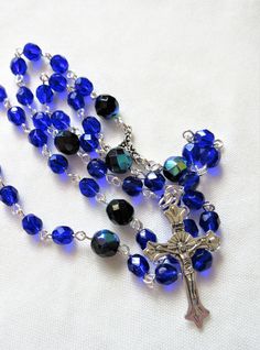 This Lutheran rosary is made with 6mm cobalt blue crystals. 8mm beads were used for the larger beads. The silver plated wires are hand turned. The rosary parts are silver plated pewter. The body of this rosary is about 20 inches around and the cross drop is about 4.5 inches. All of the silver plated wires are hand turned. This rosary will be slipped into a velvet bag and shipped in a bubble mailer. Blue Rosary With 8mm Beads And Crucifix, Blue Rosary With 8mm Beads In Cross Shape, Blue Rosary Bracelet For Jewelry Making, Spiritual Blue Rosary With Round Beads, Blue Spiritual Rosary Bracelet With 8mm Beads, Anglican Rosary, Irish Cross, 8mm Beads, Picasso Jasper