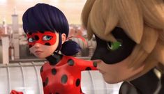 an animated ladybug and catwoman face each other