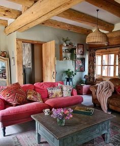 a living room filled with furniture and lots of wood beaming on the ceiling beams