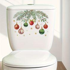 a white toilet with christmas decorations on the lid