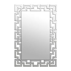 a mirror that is sitting on top of a wall with an intricate design in the middle