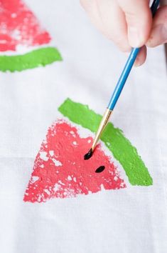 someone is painting watermelon on a t - shirt