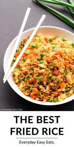 the best fried rice ever is served in a white bowl with chopsticks and green onions