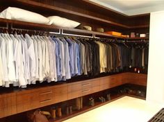 the closet is full of men's shirts and ties