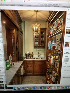 an image of a kitchen with lots of bottles on the shelves