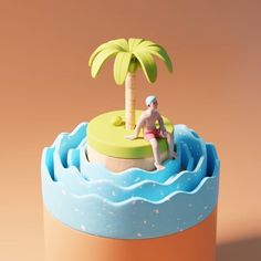 a cake with a man sitting on top of it and a palm tree in the background