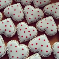 heart shaped cookies with red polka dots on them are arranged in the shape of hearts