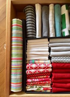 a drawer filled with lots of folded fabric