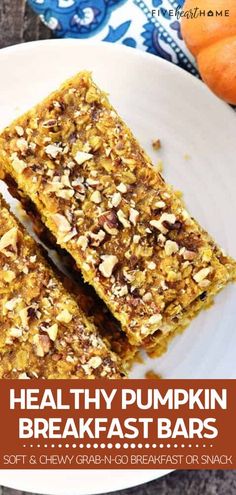 healthy pumpkin breakfast bars on a white plate with oranges in the background and text overlay