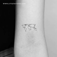 a small world map tattoo on the back of a woman's left arm,