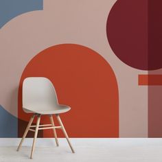 a white chair sitting in front of a colorful wall