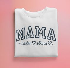 Get cozy with our Custom Mama Embroidered Sweatshirt, the perfect gift for any mom or treat yourself as a proud mama! This stylish sweatshirt is made from premium materials and features exquisite embroidery personalized with your children's names in a beautiful font. The large and comfortable crewneck design ensures a relaxed fit and the high-quality materials ensure durability and longevity. This sweatshirt is the perfect addition to any mom's wardrobe and makes a great gift for any occasion, w Family Matching Letter Print Sweatshirt As Gift, Family Matching Sweatshirt With Letter Print As Gift, Family Matching Sweatshirt With Letter Print, Family Matching White Sweatshirt With Letter Embroidery, White Family Matching Sweatshirt With Letter Embroidery, Father's Day White Sweatshirt Gift, Mother's Day Gift Tops With Letter Embroidery, Personalized White Sweatshirt For Gift, White Sweatshirt With Letter Embroidery As Gift