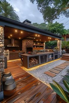 an outdoor kitchen with wood flooring and stone walls, surrounded by greenery at dusk