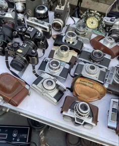 many different types of cameras sitting on a table