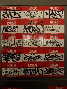 a bunch of graffiti written on the side of a wall next to each other in red and white