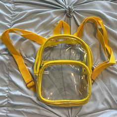 Clear Mini Backpack In Bright, Beautiful Yellow! Nwot. Super Cute And Perfect For All Those Venues That Make You Carry A Clear Bag. Smaller Zip Pocket On The Front And One Slot Pocket On The Inside. Smoke And Pet Free Home. Sorry, No Modeling Or Trades. Clear Bag, Clear Bags, Mini Backpack, Zip Pockets, Super Cute, Bag Lady, Backpacks, Pet, Yellow