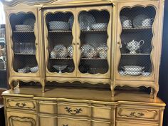 an antique china cabinet with glass doors