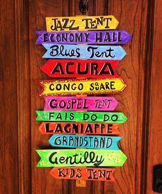 the door is decorated with colorful wooden signs