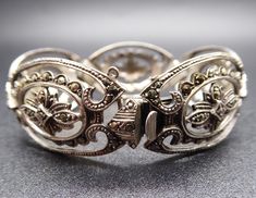 Beautiful Retro C9130s C1940s 935 Continental Silver Marcasite Bracelet in good used condition. Really nice quality German piece, has had a safety chain but one of the loops has gone, could be replaced by a jeweller. Approximate Dimensions - 20mm wide, short length 16 cm / 6.25 inches Weight - 23.68 grams Era - C1940s Hallmarks - marked 935 and acid tested. All gemstones in my listings have been examined and verified by Gemmologist Kate Matthews FGA. All pieces are in original vintage/antique co Formal Antique Silver Bracelets, Antique Oval Silver Bracelets, Antique Silver Oval Bracelets, Vintage Sterling Silver Bracelet With Intricate Design For Anniversary, Classic Antique Silver Bracelets For Formal Occasions, Classic Antique Silver Bracelet For Formal Occasions, Vintage Sterling Silver Jubilee Bracelet For Wedding, Estate Style Silver Jewelry Gift, Estate Style Silver Jewelry For Gifts