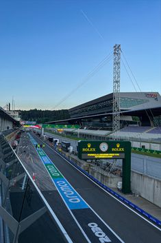 an empty race track with cars driving on it