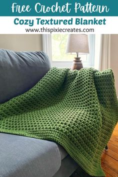 a green crocheted blanket sitting on top of a couch next to a lamp