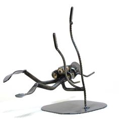 a metal sculpture of a spider with two eyes on it's body and legs