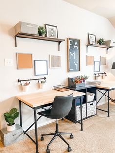 a home office with two desks and several pictures on the wall above them,