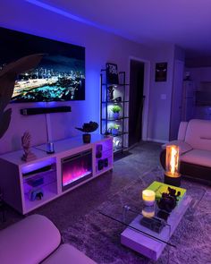 a living room filled with furniture and a flat screen tv mounted to the side of a wall