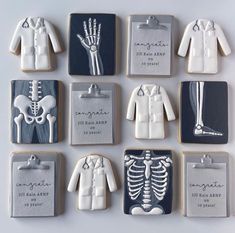 decorated cookies are arranged in the shape of human bones and skeleton images, with names on them