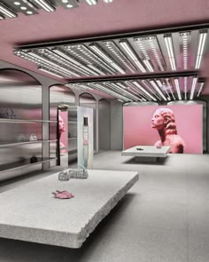 an empty room with pink lighting and various items on the table in front of it