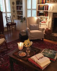 a living room filled with furniture and a fire place next to a book shelf full of books