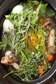 a bowl filled with meat and vegetables on top of a table