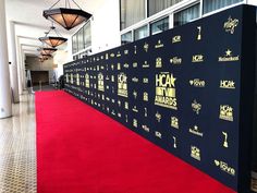 the red carpet is lined up in front of a black and white backdrop with gold lettering