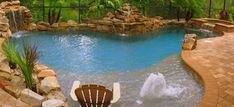 a backyard with a pool and waterfall