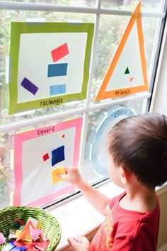 a child is looking out the window at different shapes