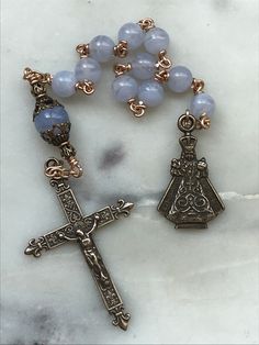 This is a beautiful, wire-wrapped, heirloom single decade rosary! The rosary is handmade with 20 gauge bronze wire. The medals and crucifix are all bronze. The beads are 6 and 8mm blue lace agate gemstones. The Rosary is the most excellent form of prayer and the most efficacious means of attaining eternal life. It is the remedy for all our evils, the root of all our blessings. There is no more excellent way of praying.~Pope Leo XIII Spiritual Wire Wrapped Rosary As Gift, Spiritual Gift Wire Wrapped Rosary, Elegant Healing Rosary With Round Beads, Handmade Bronze Rosary As A Gift, Blue Healing Rosary, Spiritual Blue Rosary With 108 Beads, Adjustable Blue Beaded Rosary, Pope Leo Xiii, Bohemian Hand-strung Healing Rosary