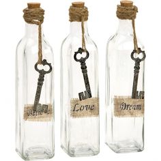 three empty bottles with keys attached to them