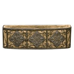 an old fashioned metal box with decorative designs on the front and sides, isolated against a white background