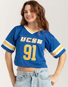 Hype And Vice Ucsb Football Jersey. Where Team Pride Meets Trendy Style. Crafted With Breathable Fabric, This Jersey Features The Iconic Ucsb Football Team Colors And Logo For A Look That Screams Team Spirit. Stretchy Rib Knit V-Neckline. Short Sleeve. Cropped Design, Relaxed Fit. 100% Polyester. Machine Wash. Imported. Model Is Wearing A Size Small. Model Measurements:height: 5'7" Bust: 32"waist: 24.5"hips: 36" Blue Varsity Style Tops, Blue Fitted Tops For College, Varsity Style Blue Top For College, Varsity Blue Tops For College, Blue School Spirit Tops For College, Blue College Tops With School Spirit, Team Spirit Fitted Tops For College, Fitted Tops For College With Team Spirit Style, Jerseys Outfit