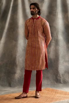 Editor's Note This set features Red linen kurta with handmade lampi stripes. Teamed with cotton lycra pants. Fabric : Linen, Cotton Lycra Color : Red Care : Dry Clean Only About the Designer Itrh makes a high-end luxury Indian ethnic wear made using exquisite and endangered age-old crafts such as kalamkari, madhubani, chikankari, zardozi, and gota weaving. The focus of the house is to cherish the beauty of handcrafted luxury designer wear. Luxury Traditional Chinon Kurta, Luxury Bohemian Jamawar Kurta, Luxury Designer Linen Kurta, Striped Kurta, Organza Kurta, Blouse Yoke, Red Kurta, Mens Kurta, Indian Fashion Designers