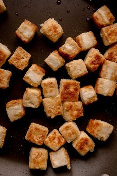 cubes of food cooking in a frying pan