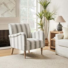 a living room filled with furniture and a large painting on the wall over a fire place