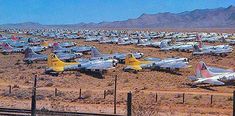 many old planes are parked in the desert