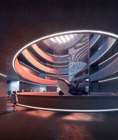 a large circular room with people standing in it and lights on the ceiling above them