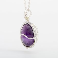 This "Murazaki" pendant necklace is handmade of 999 fine silver. It has been hand crafted in pure 99.9% solid silver in my workshop. It features a translucent Amethyst gemstone. "Murazaki" means "purple" in japanese. NOTE: This piece of jewelry has been created around this one-of-kind gemstone. It is unique and cannot be reproduced. Only one available! Silver Oval Pendant Crystal Necklace For Gift, Spiritual Silver Oval Pendant Gemstone, Sterling Silver White Gold Necklaces With Natural Stones, Spiritual Silver Gemstone With Oval Pendant, Amethyst Silver Jewelry With Polished Finish, Sterling Silver Jewelry With Large Healing Pendant, Handmade Silver Teardrop Pendant Crystal Necklace, Artisan Sterling Silver Jewelry For Meditation, Handmade Silver Crystal Necklace With Teardrop Pendant