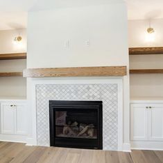 an empty room with a fireplace and shelves