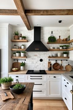 a kitchen with white cabinets and open shelvings on the wall above the stove